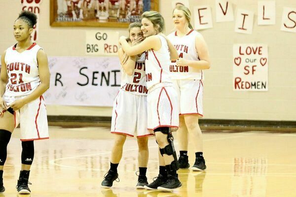 SFHS Lady Red Devil senior Halle Gore hugged her younger sister and team mate, Anna Gore during Senior Night Feb. 9. It was the first time this season the two had been able to take the floor at the same time, as Halle Gore, due to a knew injury, has not been able to participate in her senior year of play. (Photo by Jake Clapper)