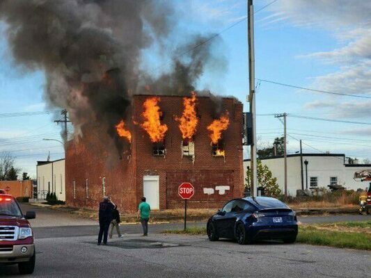 THIS BRICK STRUCTURE AT THE CORNER OF MAIN AND WASHINGTON STREETS IN FULTON WAS ENGULFED A SHORT TIME AGO, WITH FULTON FIRE DEPARTMENT, FULTON COUNTY FIRE AND RESCUE, SOUTH FULTON FIRE DEPARTMENT, WATER VALLEY FIRE DEPARTMENT, UNION CITY AND MARTIN FIRE DEPARTMENTS AT THE SCENE. UTILITY SOURCES MAY BE EXPERIENCING OUTAGES IN THE AREA. DEMOLITION IS SET TO BEGIN SHORTLY, ACCORDING TO FULTON CITY MANAGER AND FULTON VOLUNTEER FIREFIGHTER MIKE GUNN. EARLY ON, THERE WAS CAUSE FOR CONCERN, WHEN THERE WAS A POSSIBILITY A FAMILY MEMBER OF THE PROPERTY OWNER COULD HAVE BEEN INSIDE THE BUILDING, HOWEVER GUNN SAID CONTACT HAD BEEN MADE WITH THE FAMILY MEMBER.