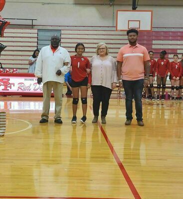 SENIOR NIGHT RECOGNITION – Shaylyn Brown and her parents were recognized during Senior Night festivities held to honor senior volleyball players for the Lady Red Devils Sept. 22. (Photo submitted)