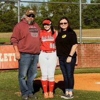 SENIOR NIGHT FOR THE LADY RED DEVILS – Marli Buchanan and her parents, Heath and Christy Buchanan, received recognition during the recent honoring of senior Lady Red Devil softball players. (Photo by Jake Clapper)