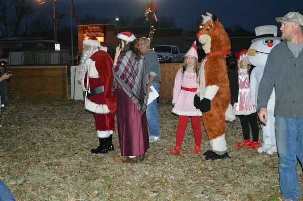CHRISTMAS VISITORS - Santa, Mrs. Claus, Rudolph, Elves, and Olaf came to the Fulton Tourism's Christmas in the Park Dec. 4 at Pontotoc Park. The characters paraded around the park and had their photo taken with those attending the event. (Photo by Barbara Atwill)