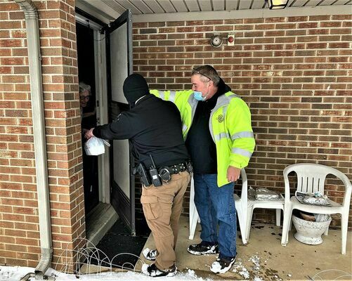 JOINING FORCES – Fulton Police Department Sgt. Tyler Nolan and Fulton County Transit Authority Meals Driver Joey Griffith recently joined forces to help deliver meals to local senior citizens during the ice and snow storms in Fulton. (Photo submitted)
