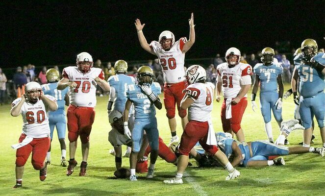 THAT’S A WINNER – South Fulton’s Eli Carlisle (20) gives the signal, after Mason Harper scored the game winning touchdown over Fulton County last Friday night. After a scoreless four quarters, Harper’s overtime score gave the Red Devils a 6-0 win at Sanger Field. (Photo by Charles Choate)