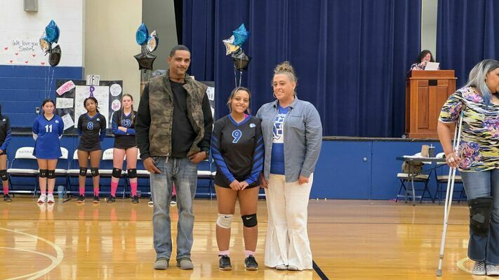 SENIOR HONORED – Fulton High School Lady Bulldog volleyball player Leandra Randle, escorted by her mother Brittany Randle, and  her father Jed Randle, was honored Oct. 20 during Senior Night festivities before the Lady Bulldogs’ home match-up versus Trigg County. She has played volleyball for two years and softball for six years. She has also been a member of the cheer squad for six years. (Photo by Mark Collier)