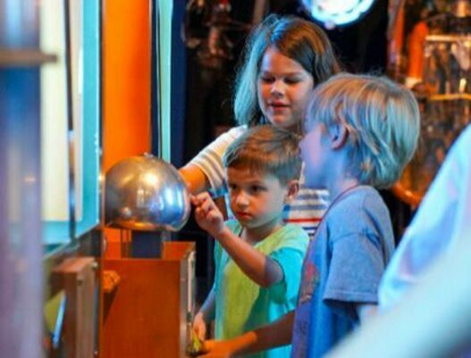 Photo Caption: (Left to right) Ellis Gray, Houston Gray and Calvin Gray use the "Van de Graaf Generator" to create static electricity at Discovery Park of America in Union City, Tenn.