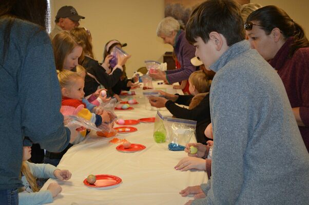 FUN DYING EGGS - Children participating in the Annual Easter egg hunt at Cayce United Methodist Church also dyed boiled eggs as one of their activities. (Photo by Barbara Atwill)