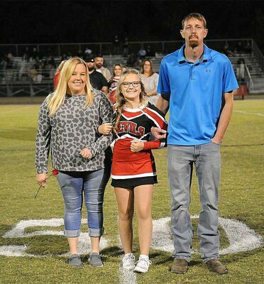 SFMS EIGHTH GRADE CHEERLEADERS HONORED – Chloe Clapper, eighth grade cheerleader for the South Fulton Middle School Red Devils, along with her parents, were recognized during Eighth Grade Night ceremonies during the Sept. 29 SFMS vs. Dresden game. (Photo by David Fuzzell)