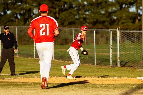 Senior Red Devils Eli Carlisle and Cade Malray  saw their team record a win at home on Monday hosting Lake County’s Falcons. (Photo by Jake Clapper)