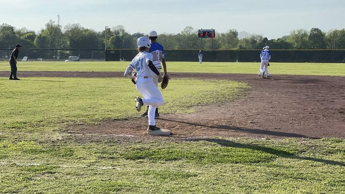 Pilot James Parker crosses first base and contemplates a move to second in the second inning of the first game of a doubleheader versus the Fulton City Bulldogs April 24. (Photo by Mark Collier)